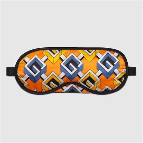 Geometric G print sleep mask in yellow silk satin .